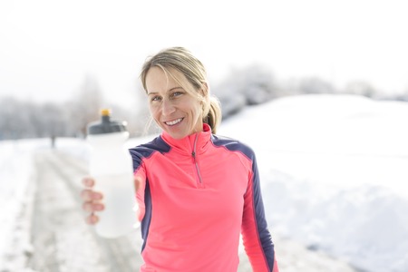 A Fitness running woman in winter seasonの写真素材