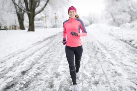 A Fitness running woman in winter seasonの写真素材