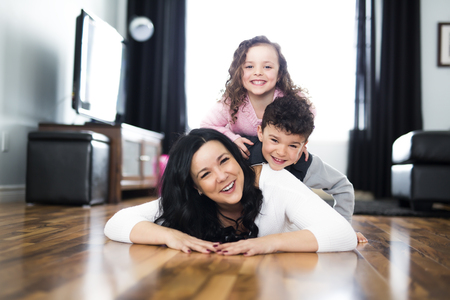 A Portrait of mother with her two children at homeの写真素材