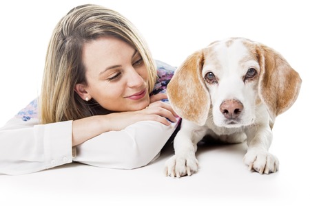 A Dog with woman are posing in studio - isolated on white backgroundの写真素材