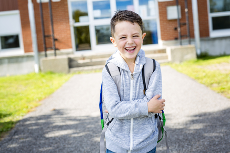 student outside school standing smilingの写真素材