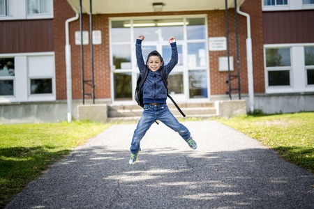 student outside school standing smilingの写真素材