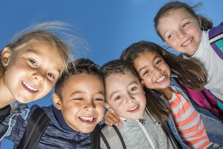 students outside school standing togetherの写真素材