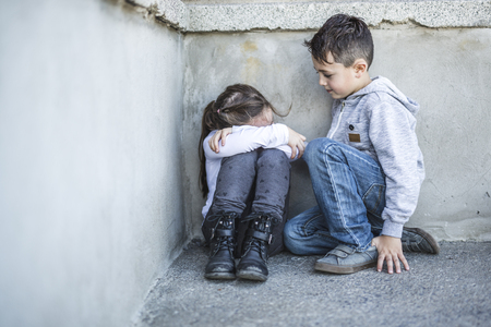 six years old sad school at the schoolyardsの写真素材