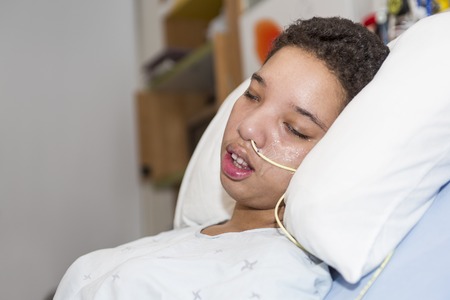 Sick patient lying on bed in hospital for medical backgroundの写真素材