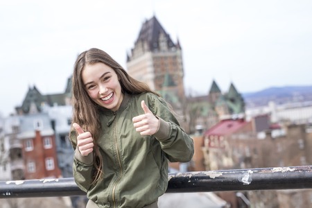 Quebec City scape with Chateau Frontenac and young teen enjoying the view.の写真素材