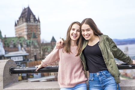 Quebec City scape with Chateau Frontenac and young friend teens enjoying the view.の写真素材
