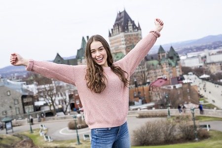 Quebec City scape with Chateau Frontenac and young teen enjoying the view.の写真素材
