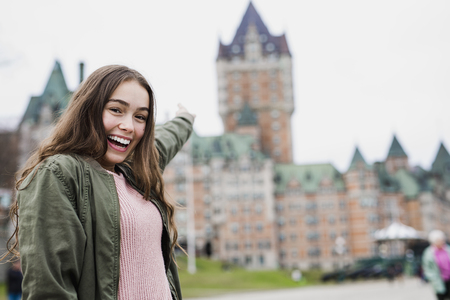 Quebec City scape with Chateau Frontenac and young teen enjoying the view.の写真素材
