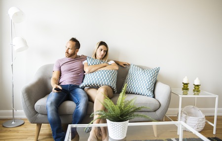 break-up Couple sitting in a comfortable couch in the livingroom at home