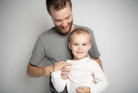 father with son in studio gray backgroundの写真素材
