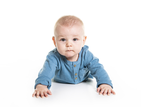 cute cheerful crawling baby boy isolated on white backgroundの写真素材