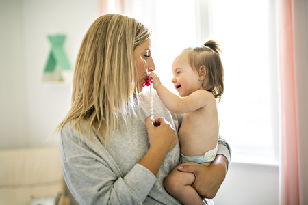 Mother and baby having good time on baby roomの写真素材