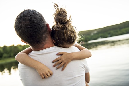 father and daughter solace on the pier warm summer day hの写真素材