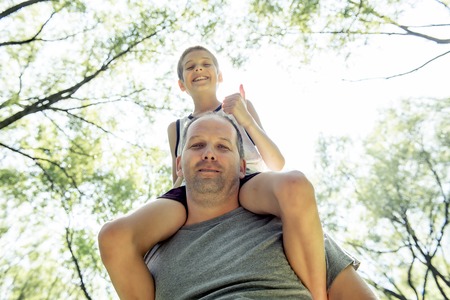 Father And Son in forest having fun togerherの写真素材