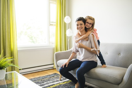 mother and daughter Having great time on the living room