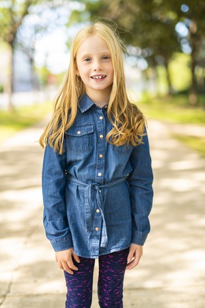 An adorable child girl outside look happyの写真素材