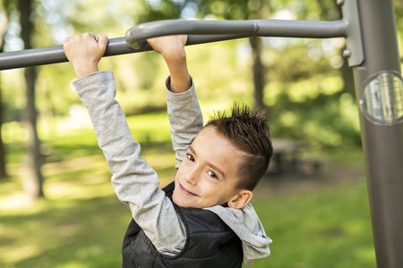 A boy having fun on the park playground