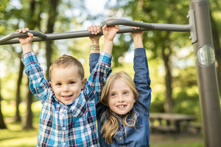 The Two young children having fun on the playgroundの写真素材