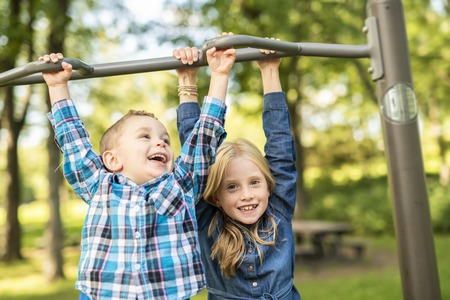 The Two young children having fun on the playgroundの写真素材