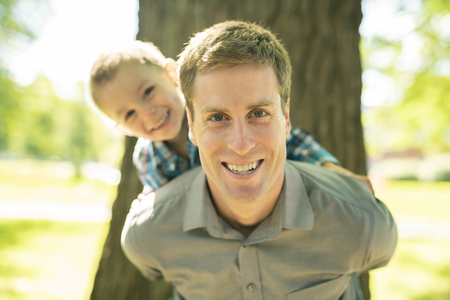 A father have fun play on park with his sonの写真素材