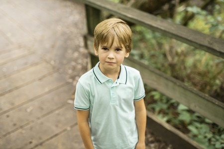 Portrait of a happy young boy outdoors forest