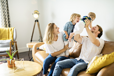 Family having fun on sofa.の写真素材