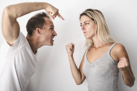 man beating helpless woman at home white backgroundの写真素材