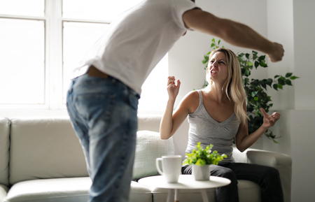 Man beating up his wife illustrating domestic violenceの写真素材