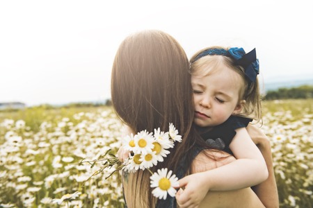 Mother spending time with daughter during the sunset.の写真素材