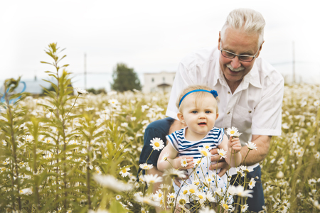 grandfather spending time with little child during the sunset.の写真素材
