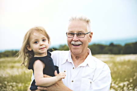 grandfather spending time with little child during the sunset.