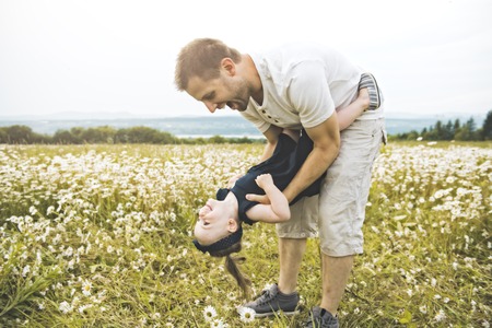 Father spending time with daughter during the sunset.の写真素材