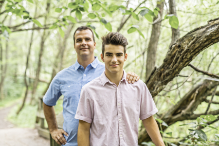 Father having fun in forest with his sonの写真素材