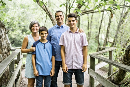 happy young family in forest having fun together