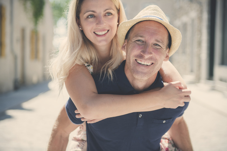 Outdoor lifestyle portrait of young couple in love in old townの写真素材