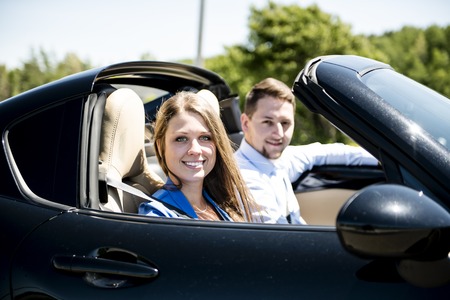 Couple enjoying a drive in a convertible