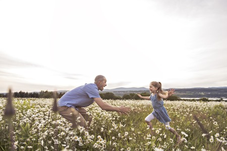 Father spending time with daughter during the sunset.の写真素材