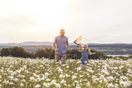 Father spending time with daughter during the sunset.の写真素材