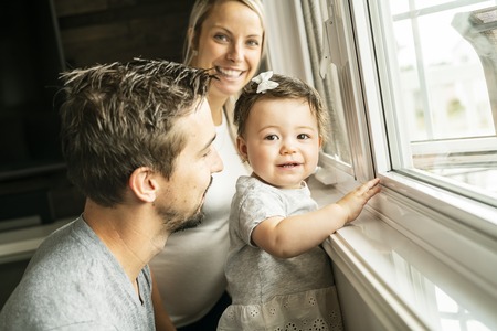 Family sit near window on the livingroomの写真素材