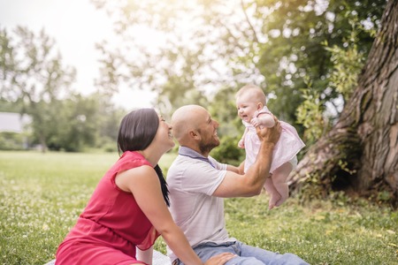 Happy family with Baby girl lay on a blanketの写真素材