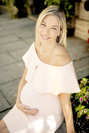 Pregnant woman on city streetの写真素材