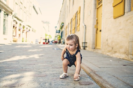 two years old child girl on urban streetの写真素材