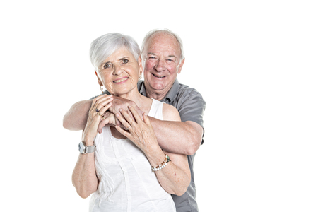 Senior couple posing on studio white backgroundの写真素材