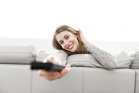 Young woman on a sofa on the living roomの写真素材