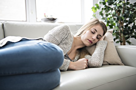 Beautiful young woman is sleeping and seeing sweet dreams.
