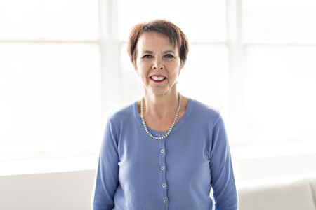 A Happy joyful senior lady looking at camera and smiling