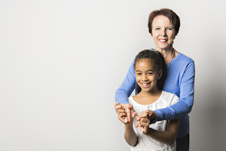 black girl child with grandmother in studio white backgroundの写真素材