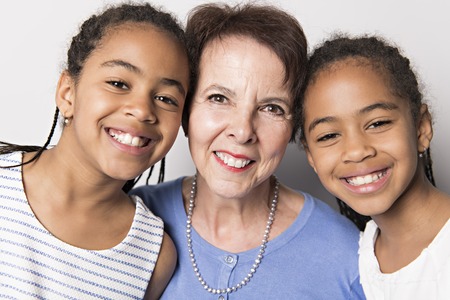 black twin girls child with grandmother in studio white backgroundの写真素材