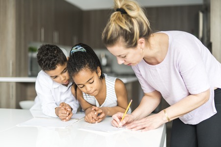 mother write note on the kitchen tabl with the childsの写真素材